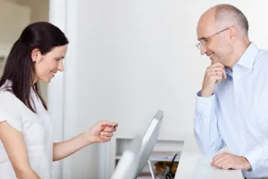 man checking in to dental office