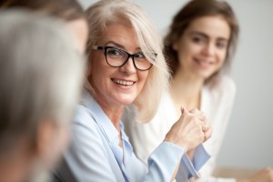 Older woman at table with others